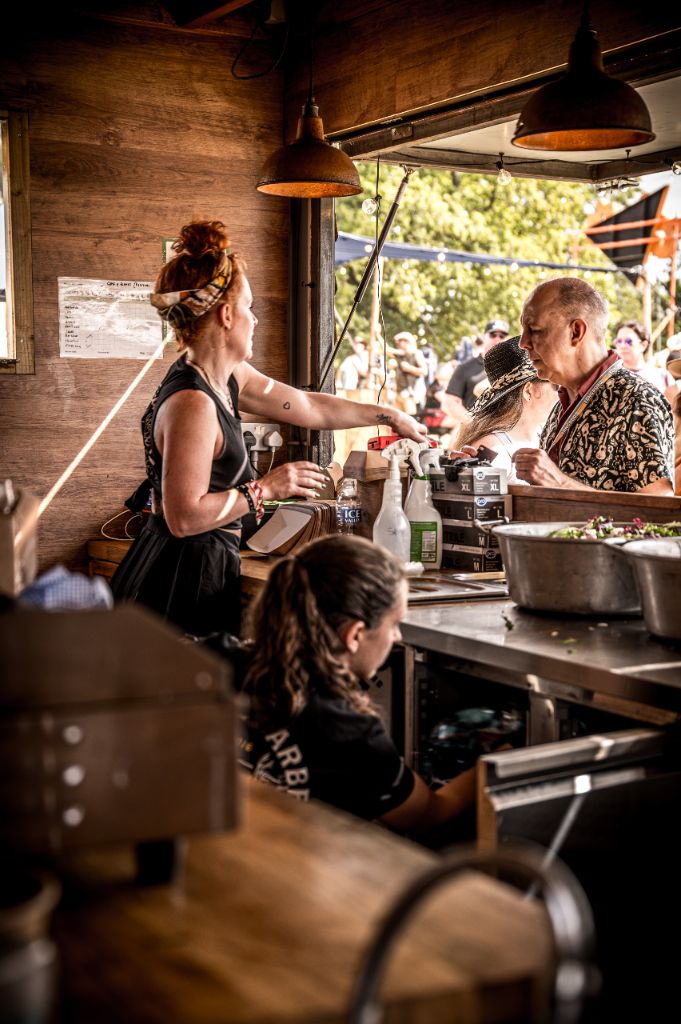 Team serving customers through the hatch at a festival