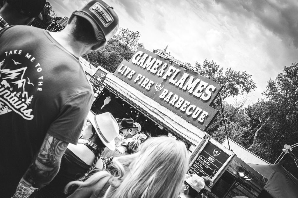 Black and white crowd shot at Game and Flames Live Fire Barbecue stand