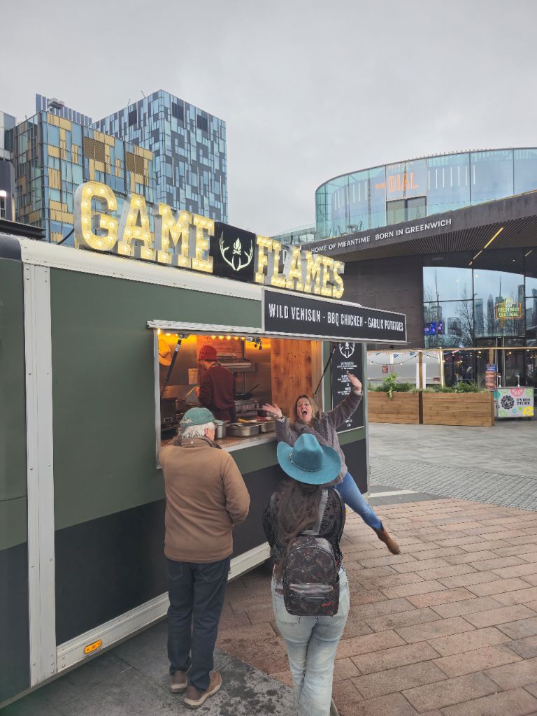 Happy customer at Game and Flames truck in Greenwich