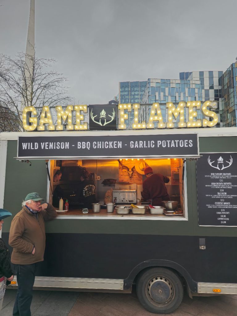 Game and Flames food truck lit up at night