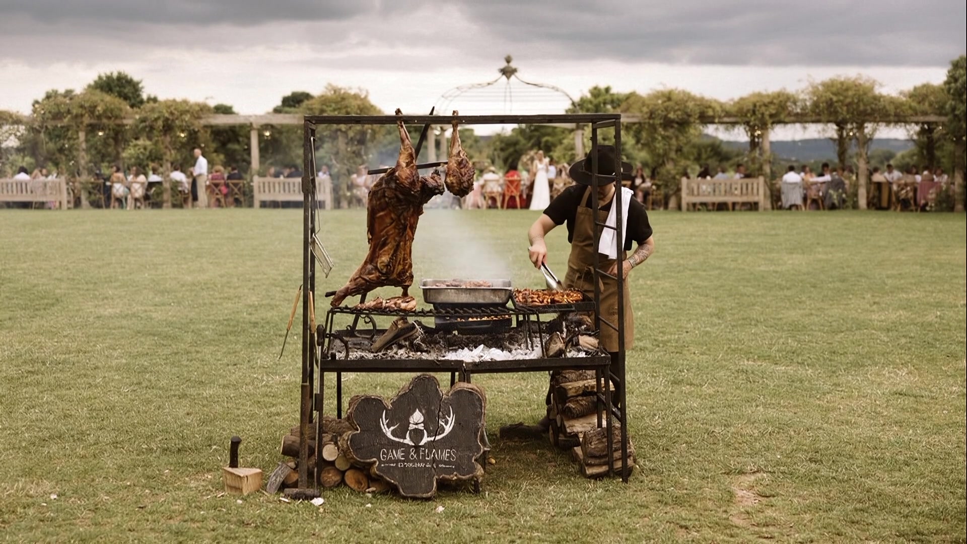 Cai Ap Bryn cooking at the Game and Flames fire grill at an outdoor wedding