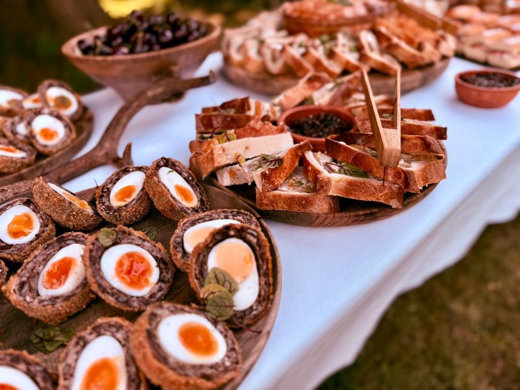 Scotch eggs, charcuterie and artisan bread spread at a Game and Flames outdoor event