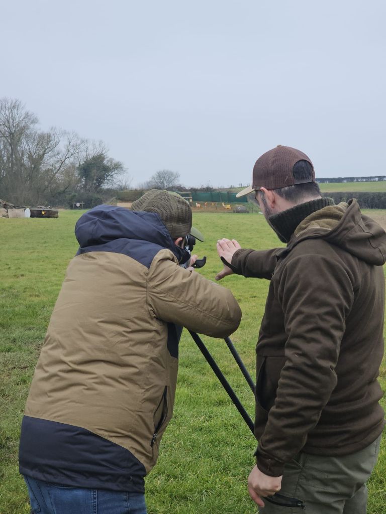 Instructor coaching a student during a PDS Level 1 rifle assessment on the range